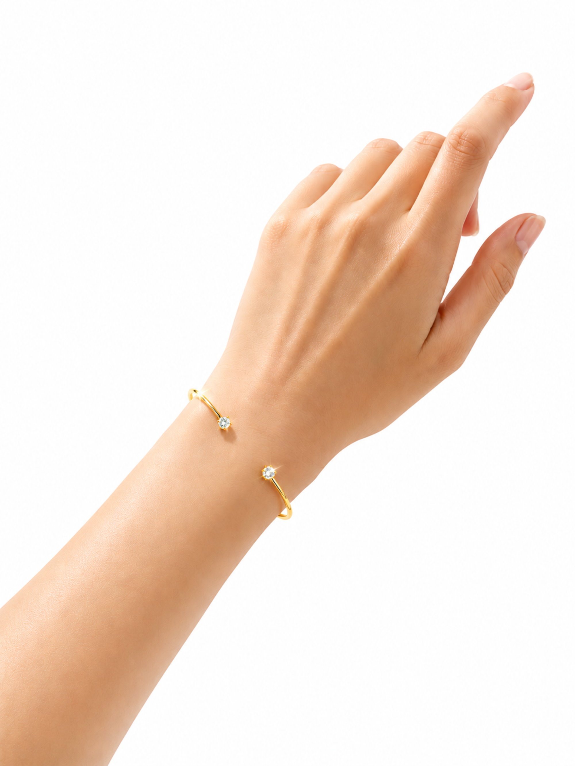 A delicate gold open bracelet with two small curved bars, each set with a tiny clear gemstone, shown worn on a person's wrist against a plain white background.