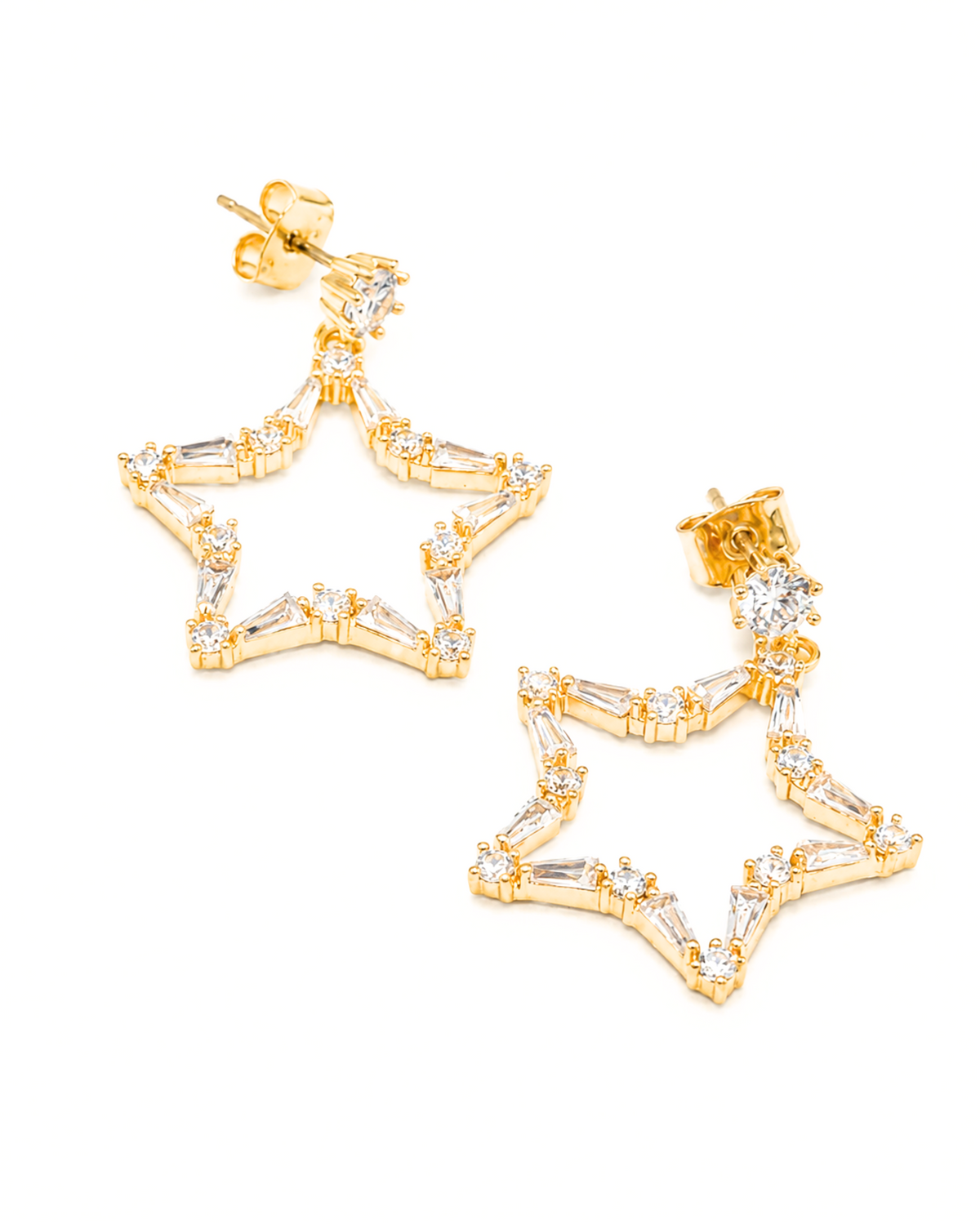 A pair of gold star-shaped dangle earrings embellished with clear baguette and round crystals, shown on a plain white background.