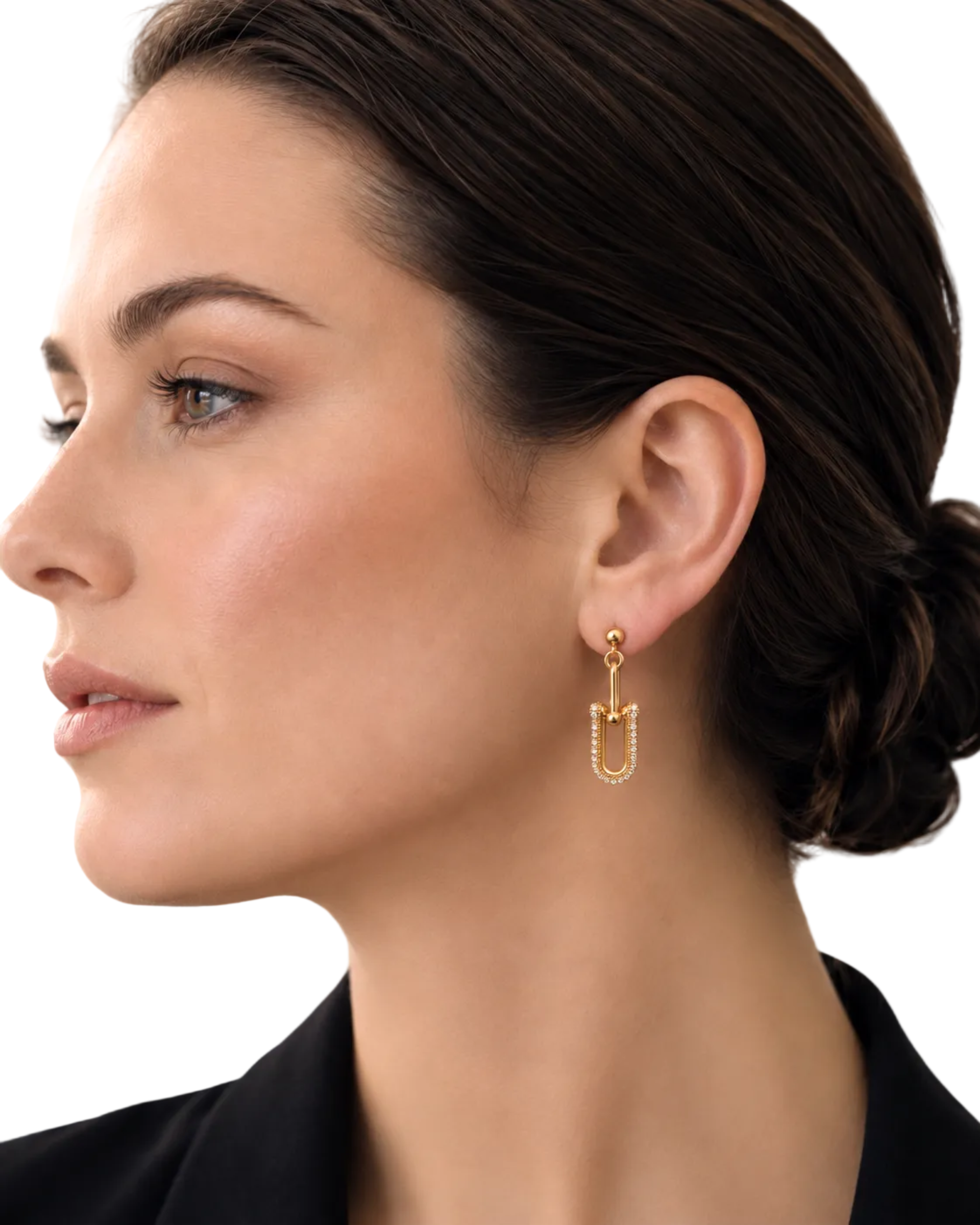 A close-up side profile of a woman wearing a delicate gold drop earring with a small textured rectangular charm, set against a clean white background.