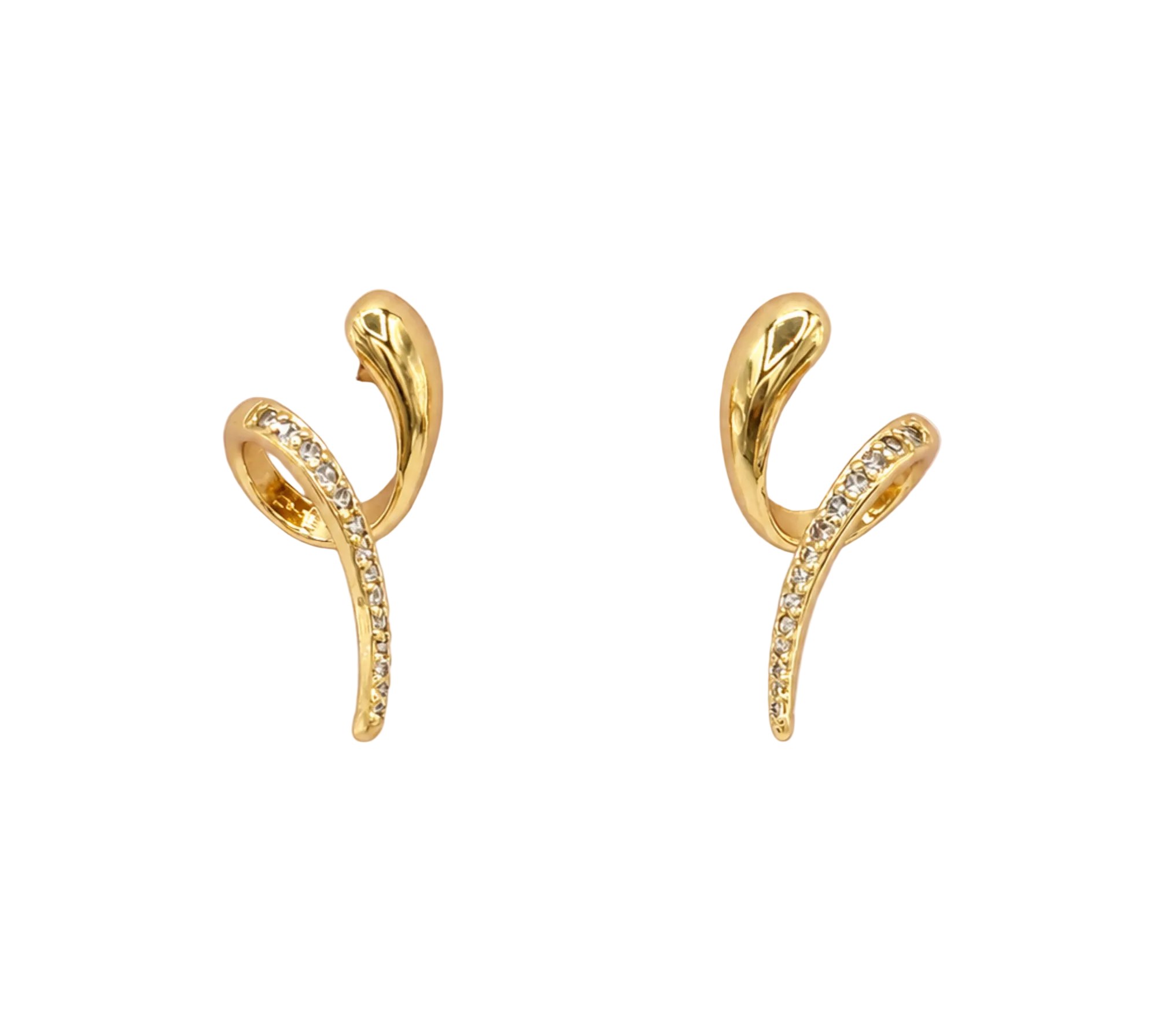 A pair of gold huggie hoop earrings with a curved, leaf-like design and a row of small clear crystals, displayed on a light pink background.
