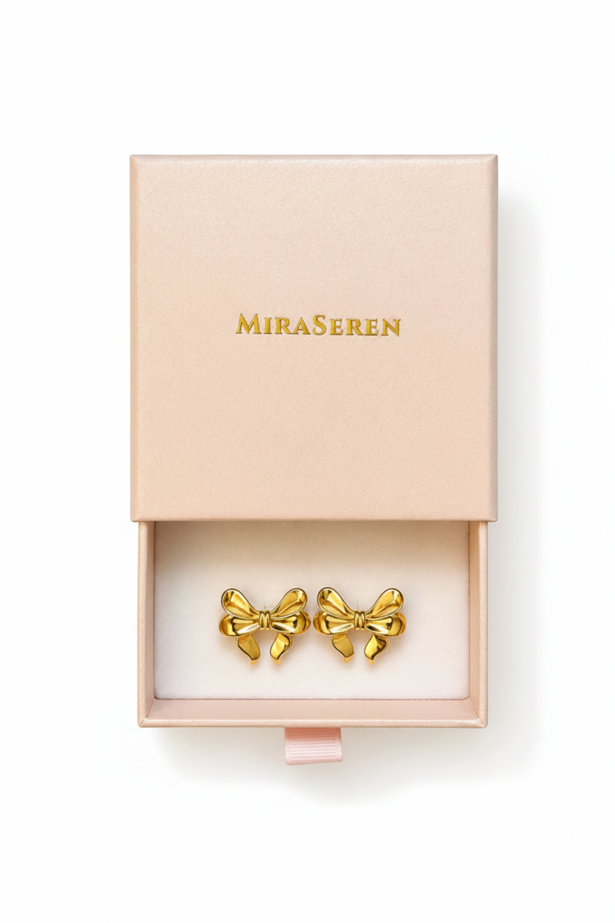 A pair of gold bow-shaped stud earrings displayed in an open pale pink Miraseren jewelry box on a white background.