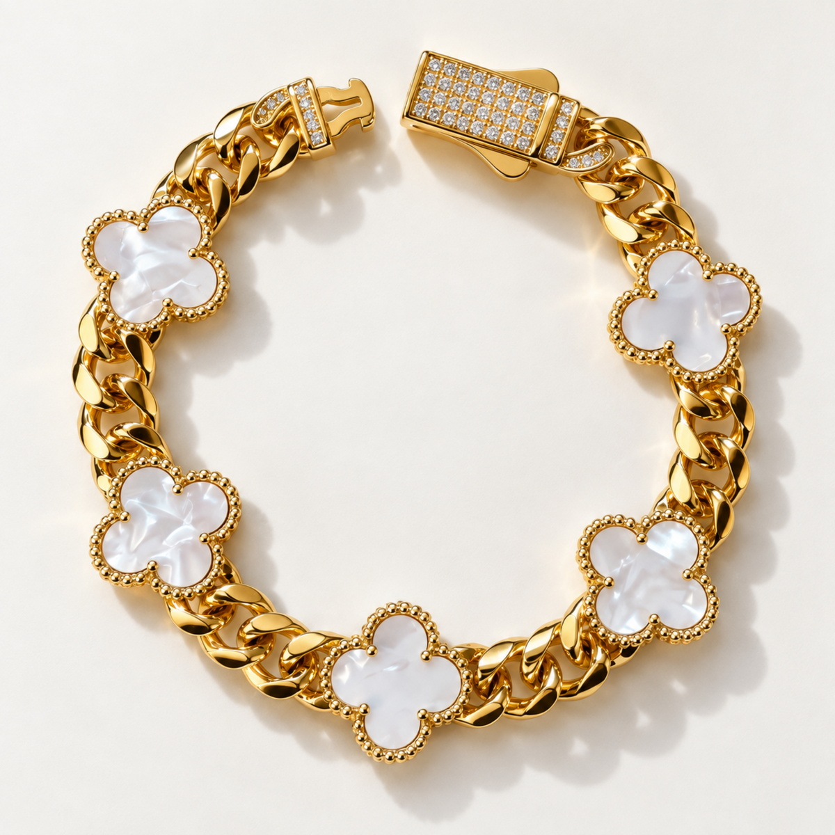 A gold-toned chain bracelet with six clover-shaped links featuring milky white inlays, displayed on a clean white background.