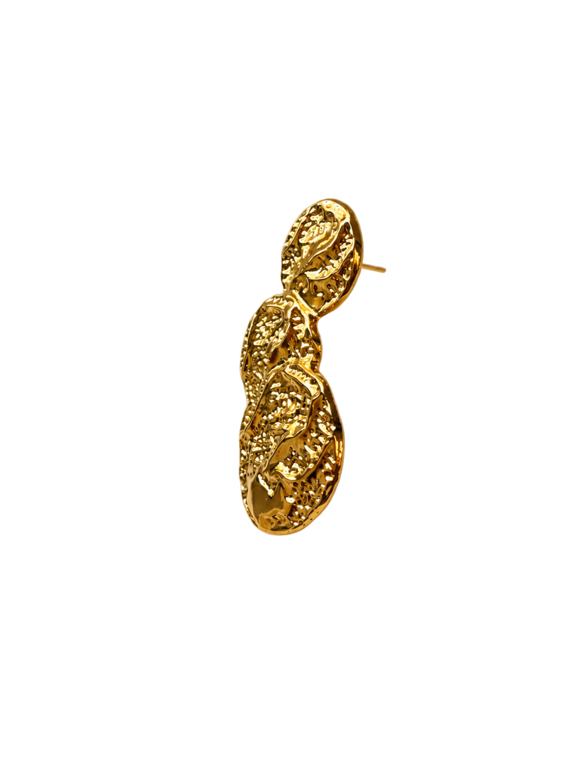 A single textured gold statement earring with a sculptural, organic shape, photographed against a warm beige satin fabric backdrop with soft diagonal light streaks.