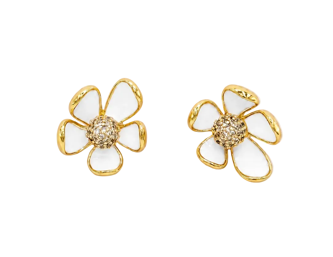 A pair of gold flower-shaped stud earrings with white enamel petals and a textured gold center, shown on a plain white background.