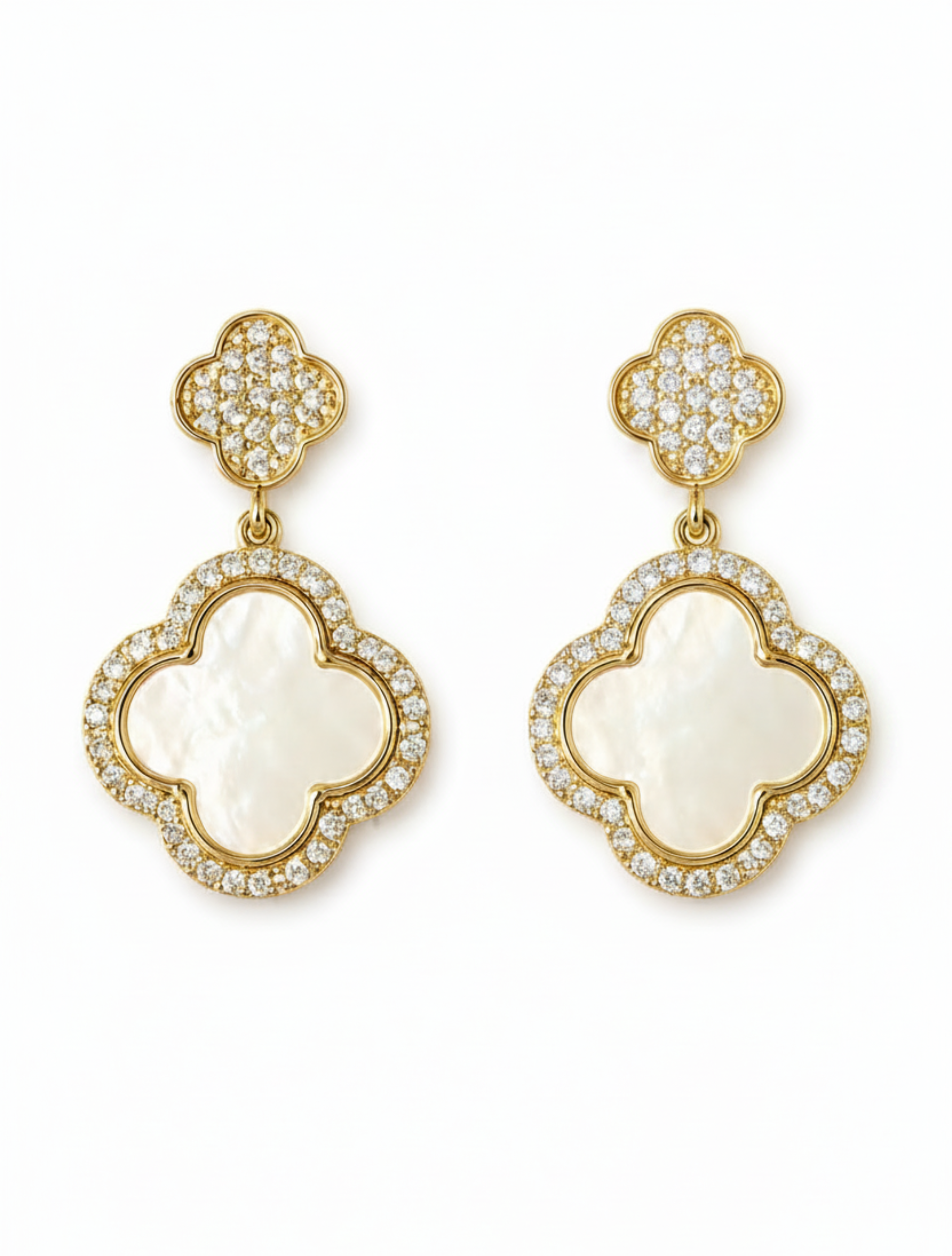 A pair of gold clover drop earrings featuring a large white mother-of-pearl clover face surrounded by pavé-set clear stones, with smaller matching clover studs above, shown on a plain white background.
