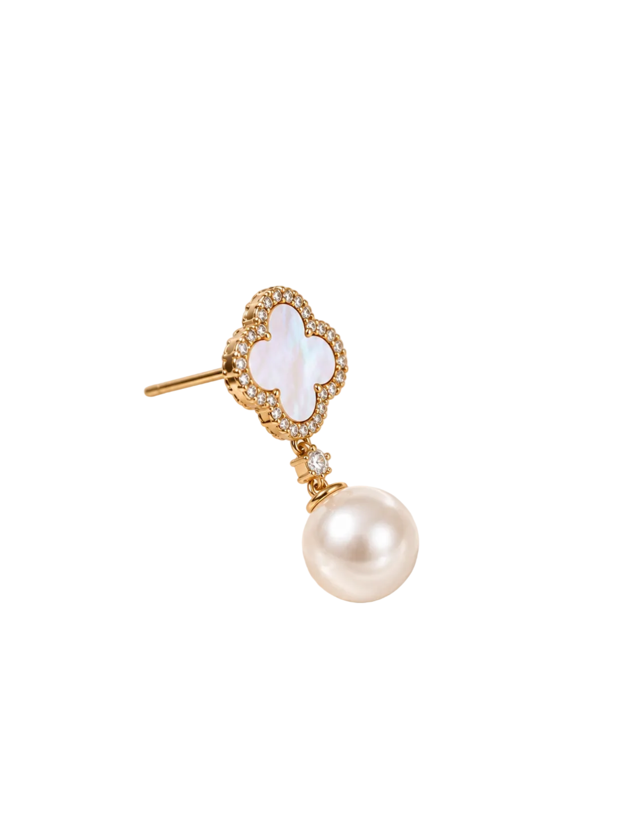 A gold-toned drop earring featuring a four-leaf clover motif with a white mother-of-pearl inlay and a dangling white pearl, photographed on a softly lit cream satin fabric background.