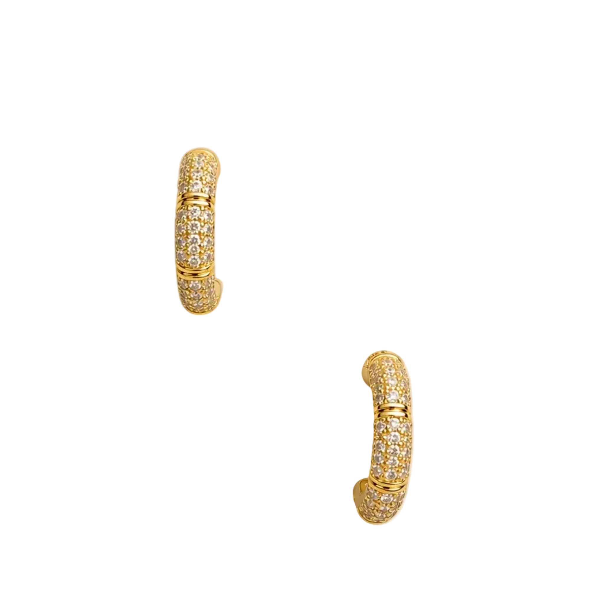 A pair of gold huggie hoop earrings paved with small clear stones, displayed on a beige rectangular jewelry card against a white background.