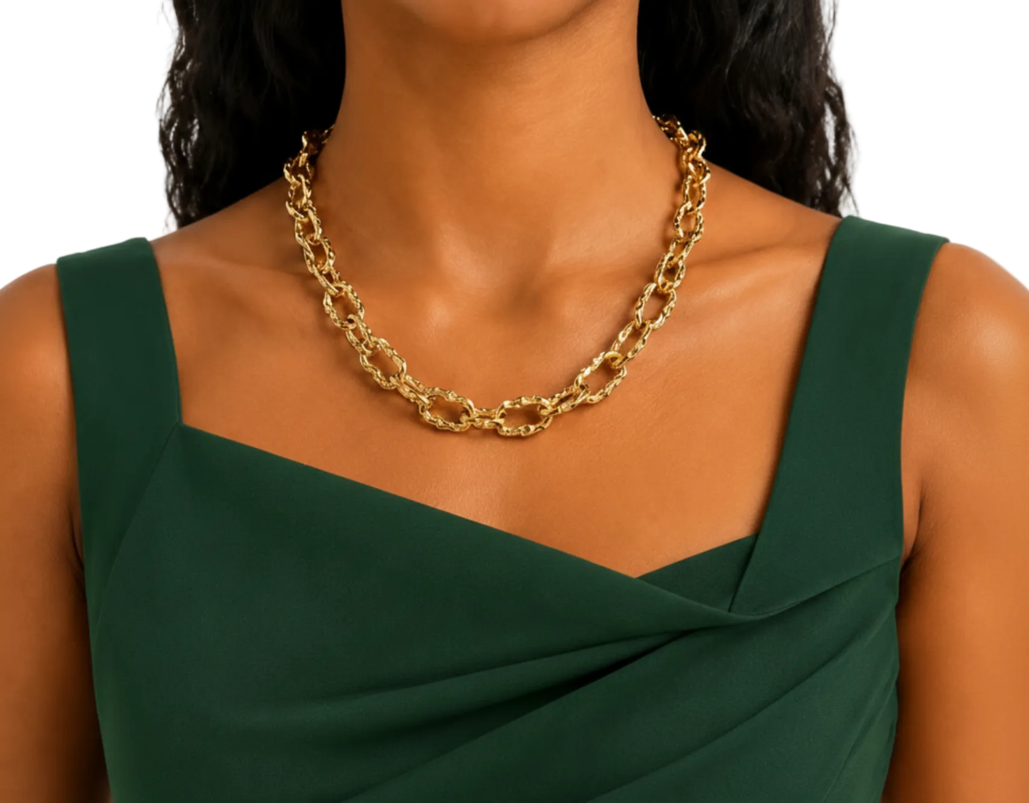 A close-up of a model wearing a chunky gold chain link necklace with a dark green draped dress.