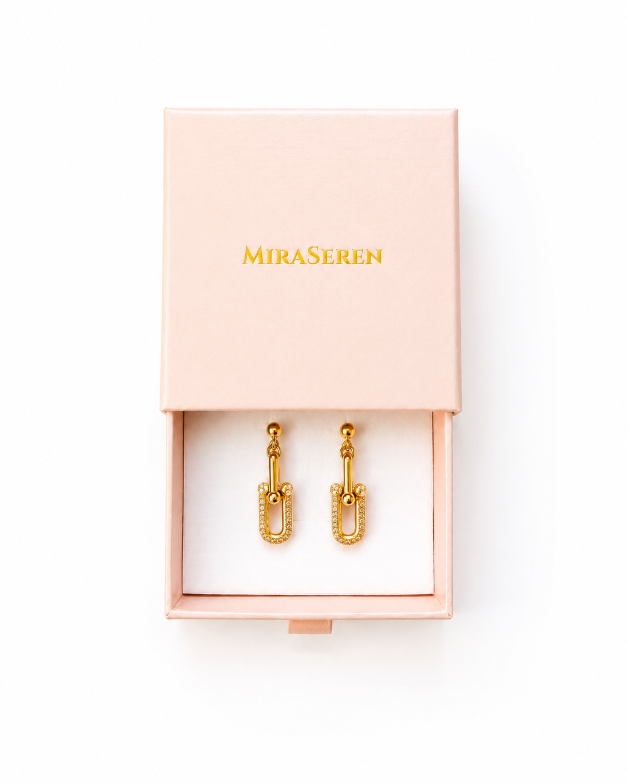 Gold U-shaped drop earrings displayed in an open light pink Miraseren jewelry box on a white background.