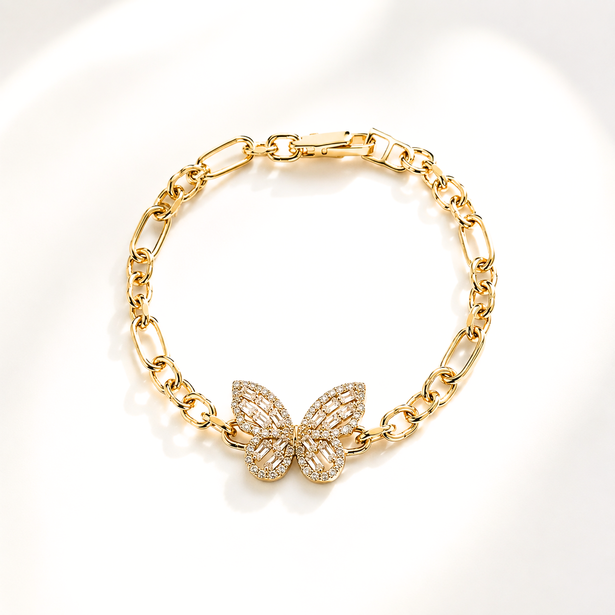 A gold chain bracelet with a butterfly-shaped centerpiece paved with clear stones, displayed on a clean white background.