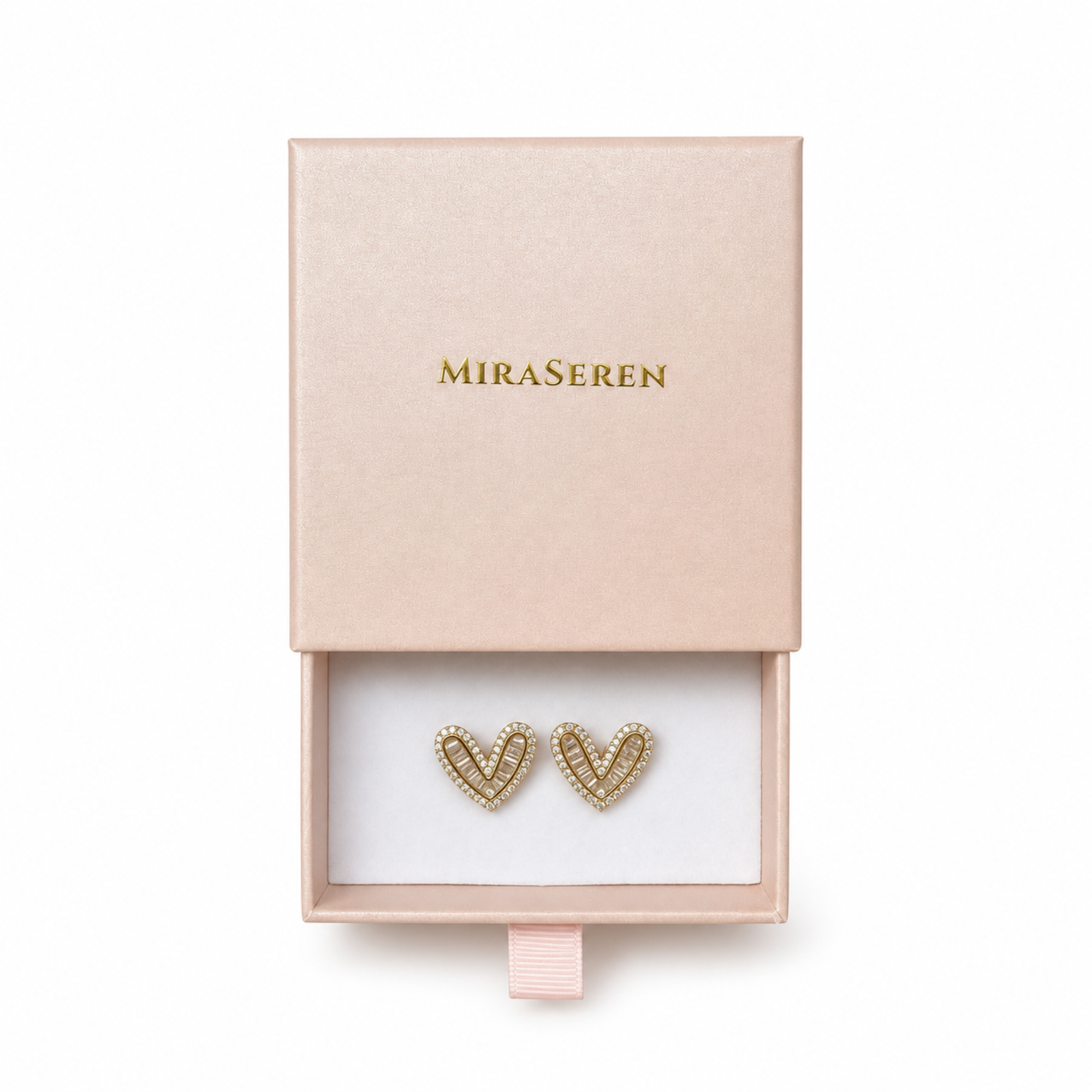 A pair of gold heart-shaped stud earrings with clear pavé detailing, presented in a pink Miraseren box with the lid partially open.