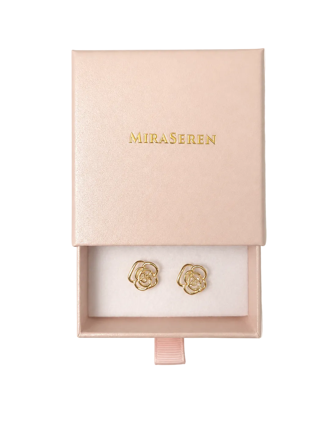A pair of gold rose-shaped stud earrings displayed inside an open pale pink jewelry box with the brand name 'MIRA SEREN' in gold lettering on the lid, set against a clean off-white background.