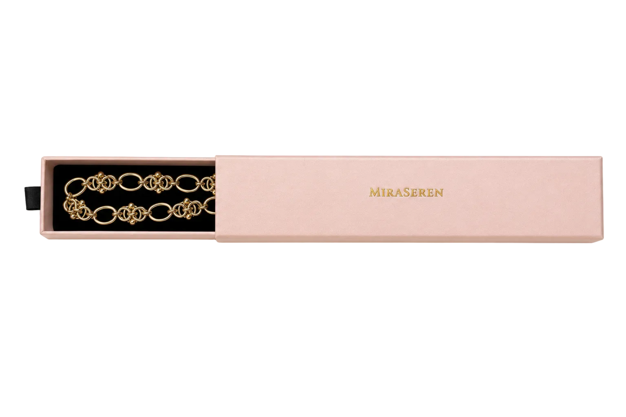 A gold chain bracelet with interlocking double-oval links, displayed inside an open blush pink jewelry box with the brand name 'MIRA SEREN' printed in gold on the lid, set against a plain white background.