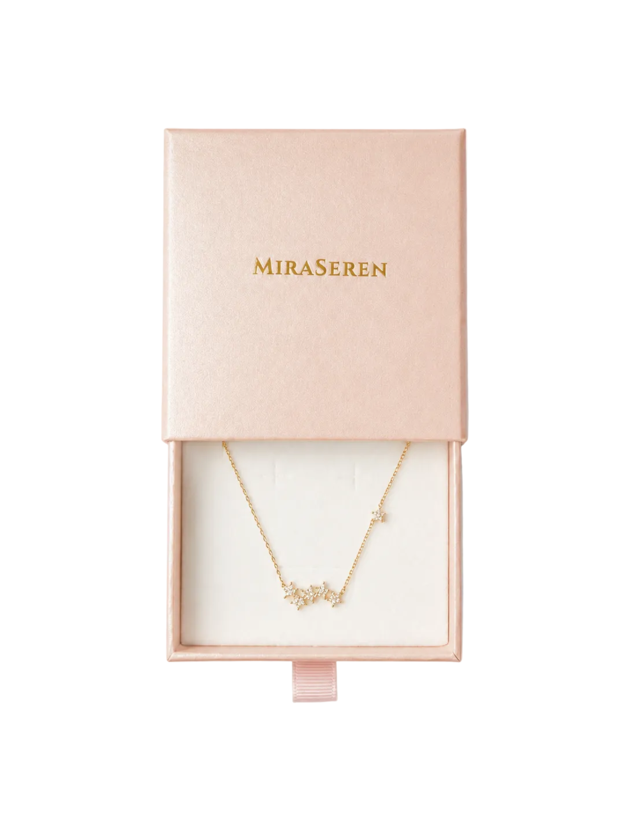 A gold initial necklace with clear stones spelling 'MIRA' and 'SEREN', presented in a pink Miraseren gift box on a white background.