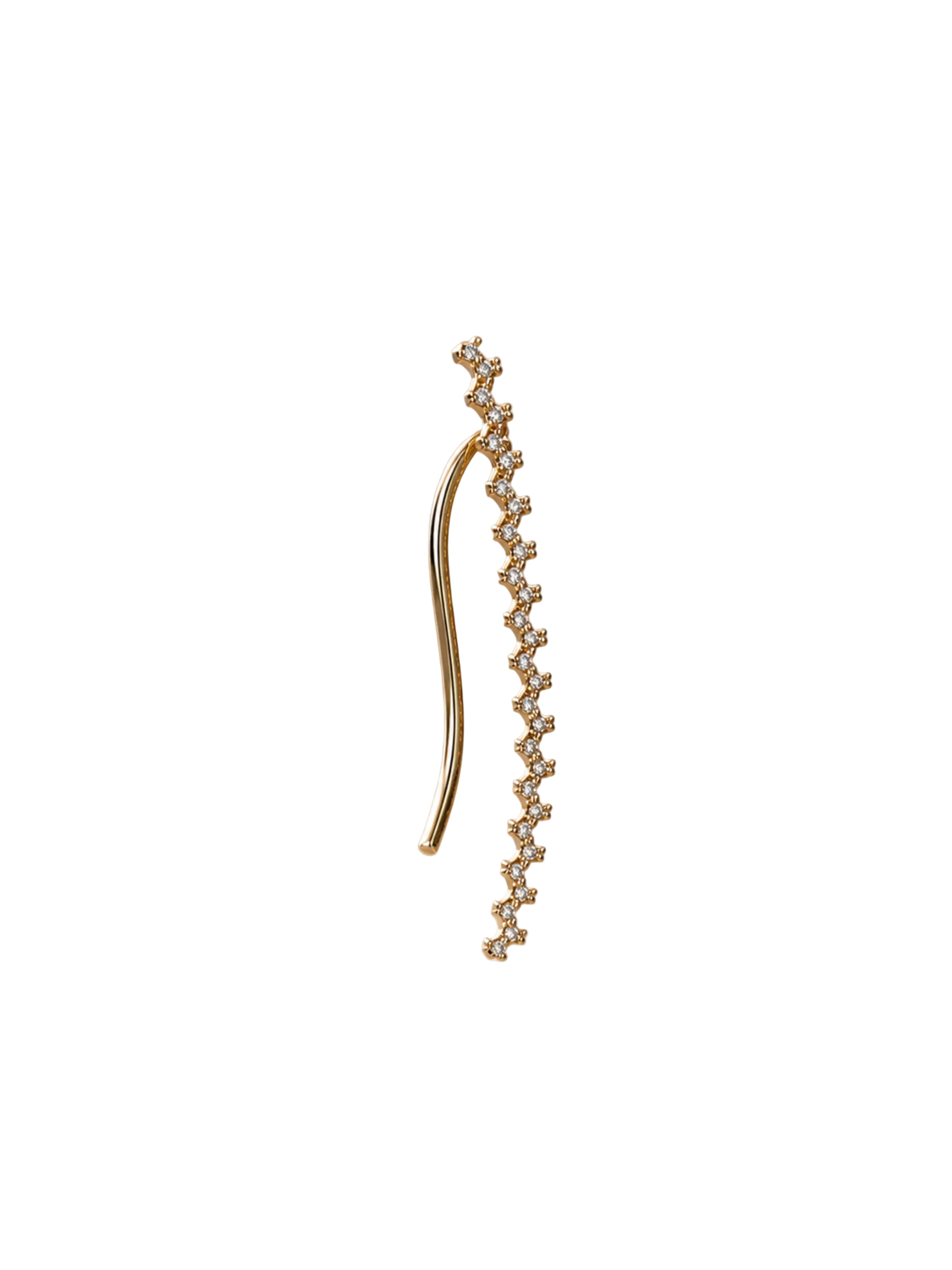 A delicate gold ear cuff with a curved main bar and a dangling zigzag line of small clear stones, photographed on a softly lit beige satin surface with diagonal light rays.