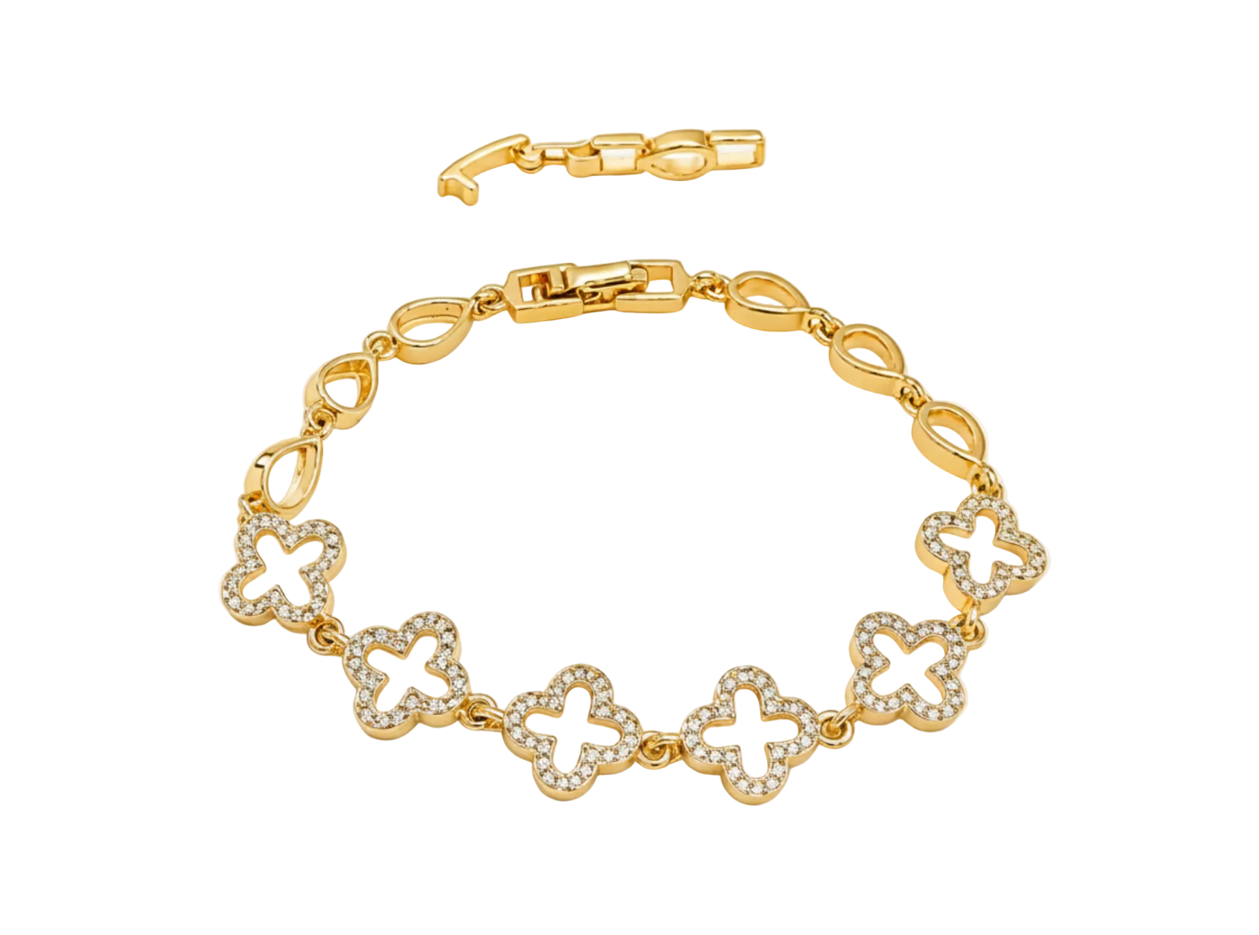 A gold bracelet featuring five interlocking clover motifs, each adorned with small clear crystals, displayed on a soft, light beige fabric background.