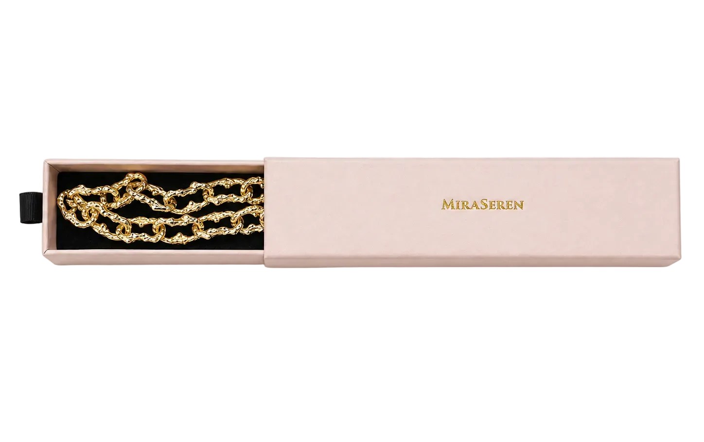 A gold chain necklace presented in an open pale pink rectangular box with the brand name MIRA SEREN printed in gold on the lid, photographed on a clean white background.