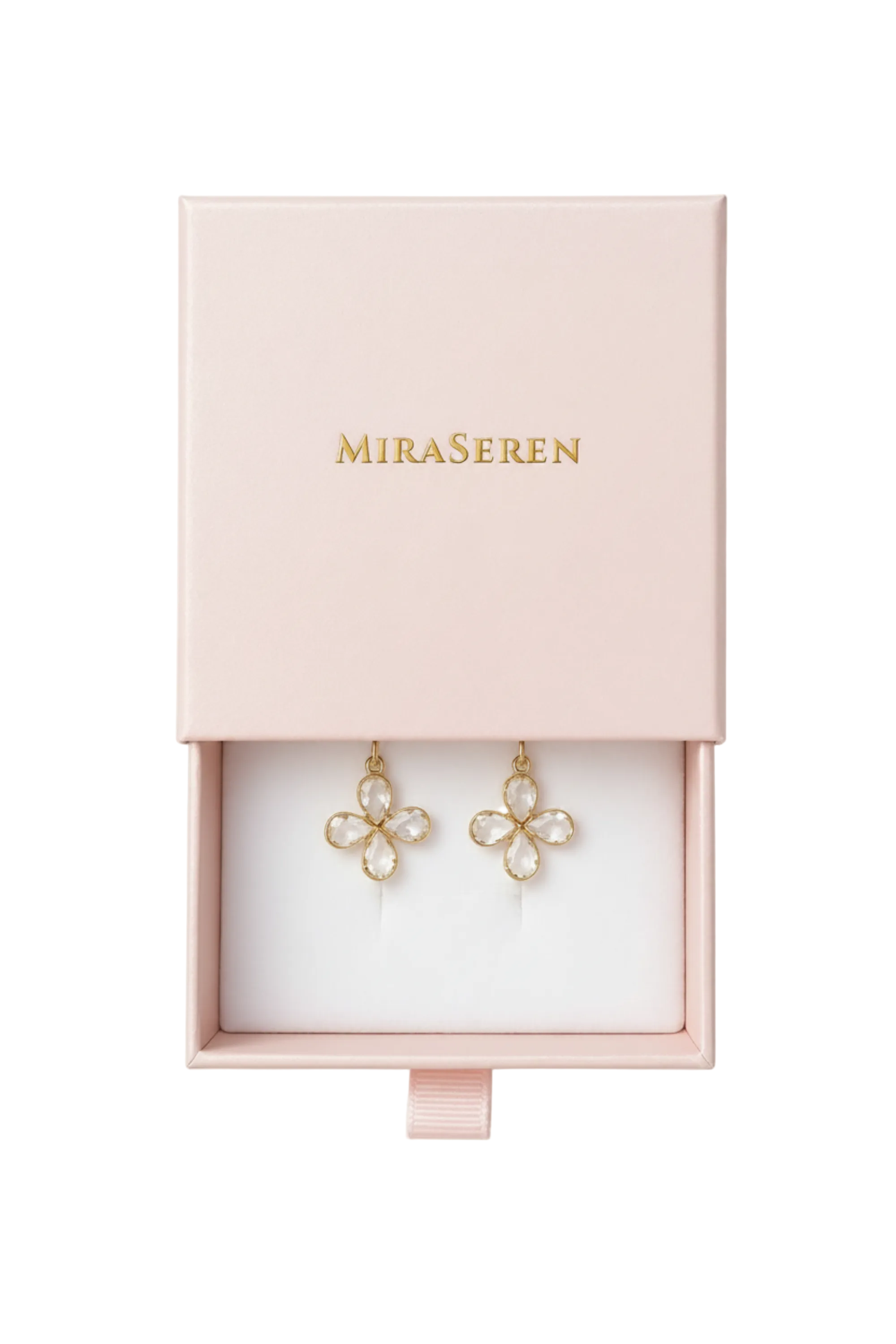 MiraSeren gold-tone flower-shaped dangle earrings with clear rhinestones, presented in an open light pink jewelry box with the brand name printed in gold on the lid.