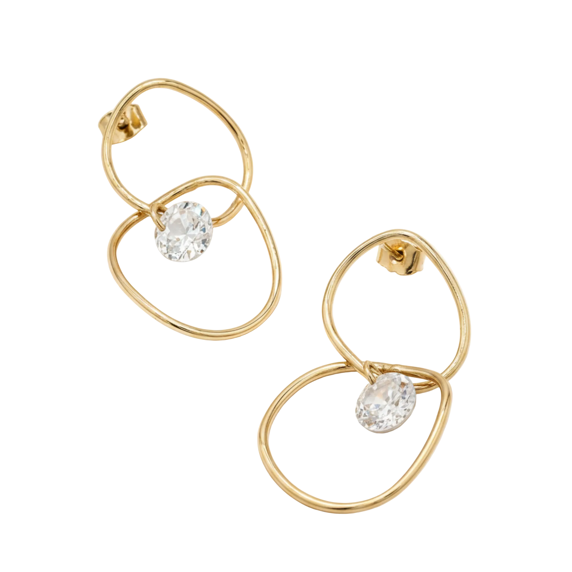 A pair of gold-toned dangle earrings with abstract overlapping oval wire frames and a clear faceted gemstone at the bottom of each earring, shown on a plain white background.