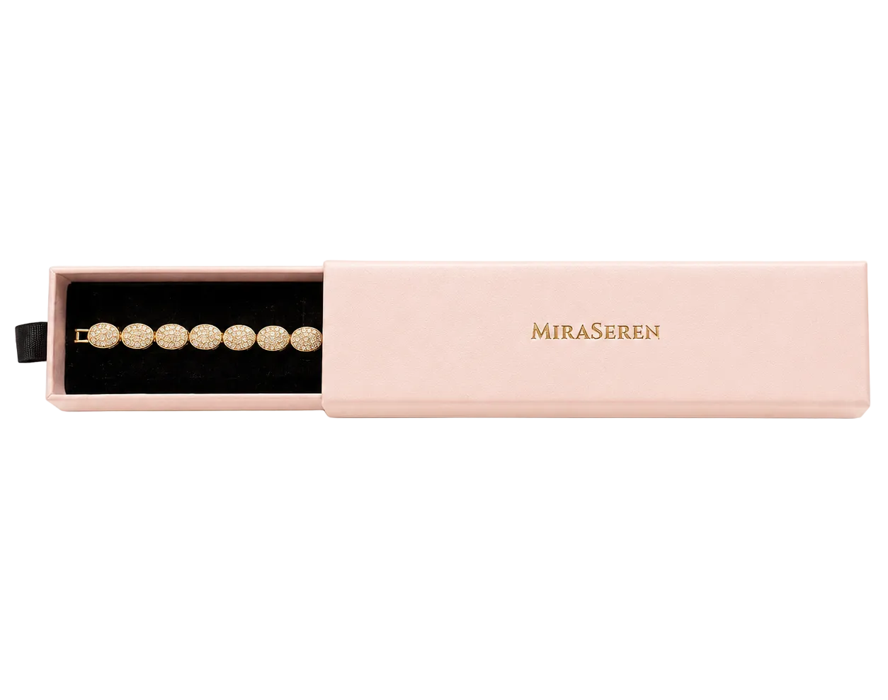A gold bracelet with round pearl-like beads displayed in an open light pink jewelry box with the brand name 'MIRA SEREN' printed in gold on the side.