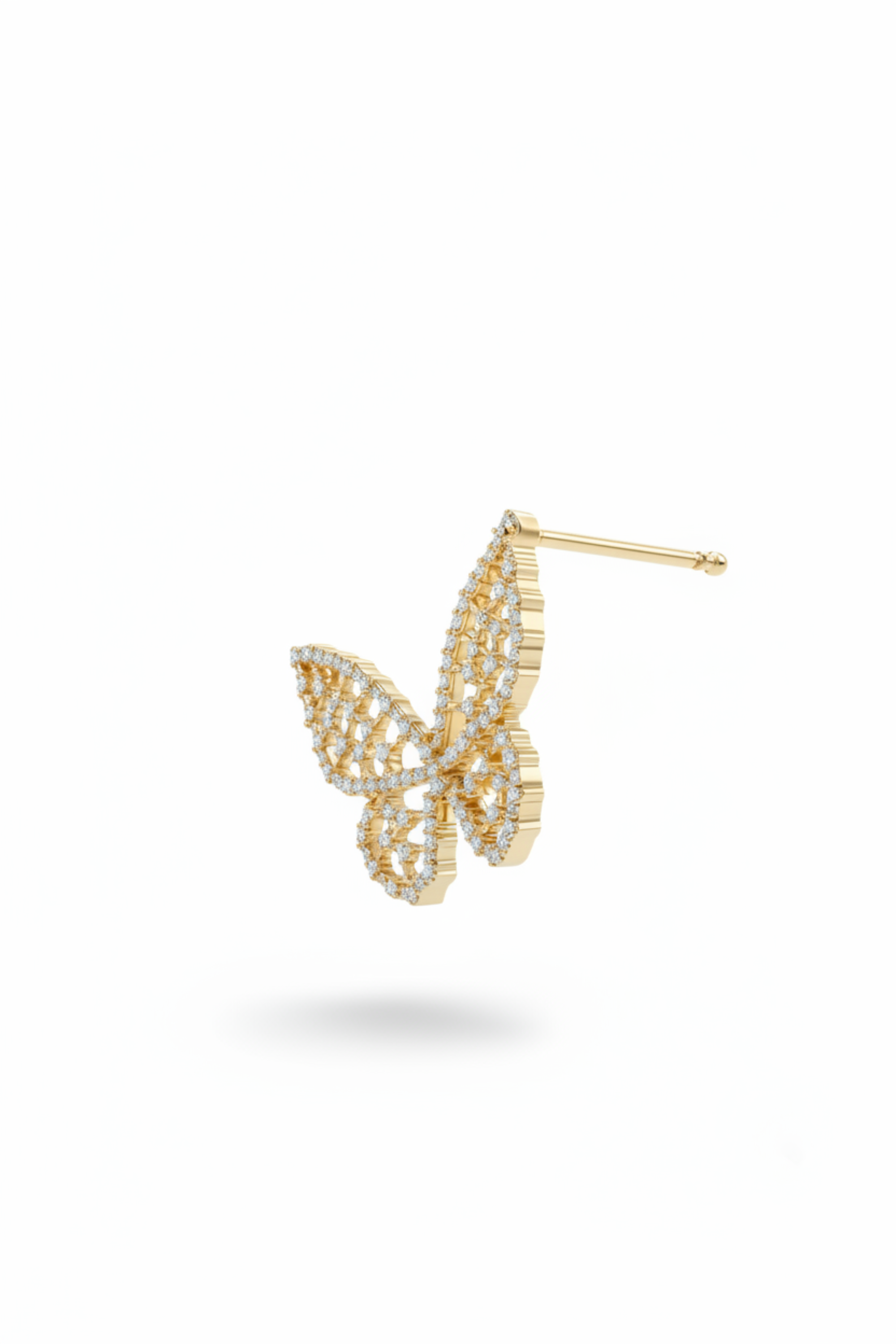 A single gold butterfly-shaped stud earring with intricate pavé detailing, shown floating against a smooth, neutral gray background.